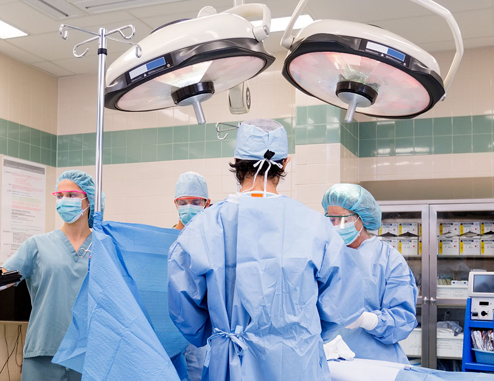 An operating room with surgeons in their blue scrubs