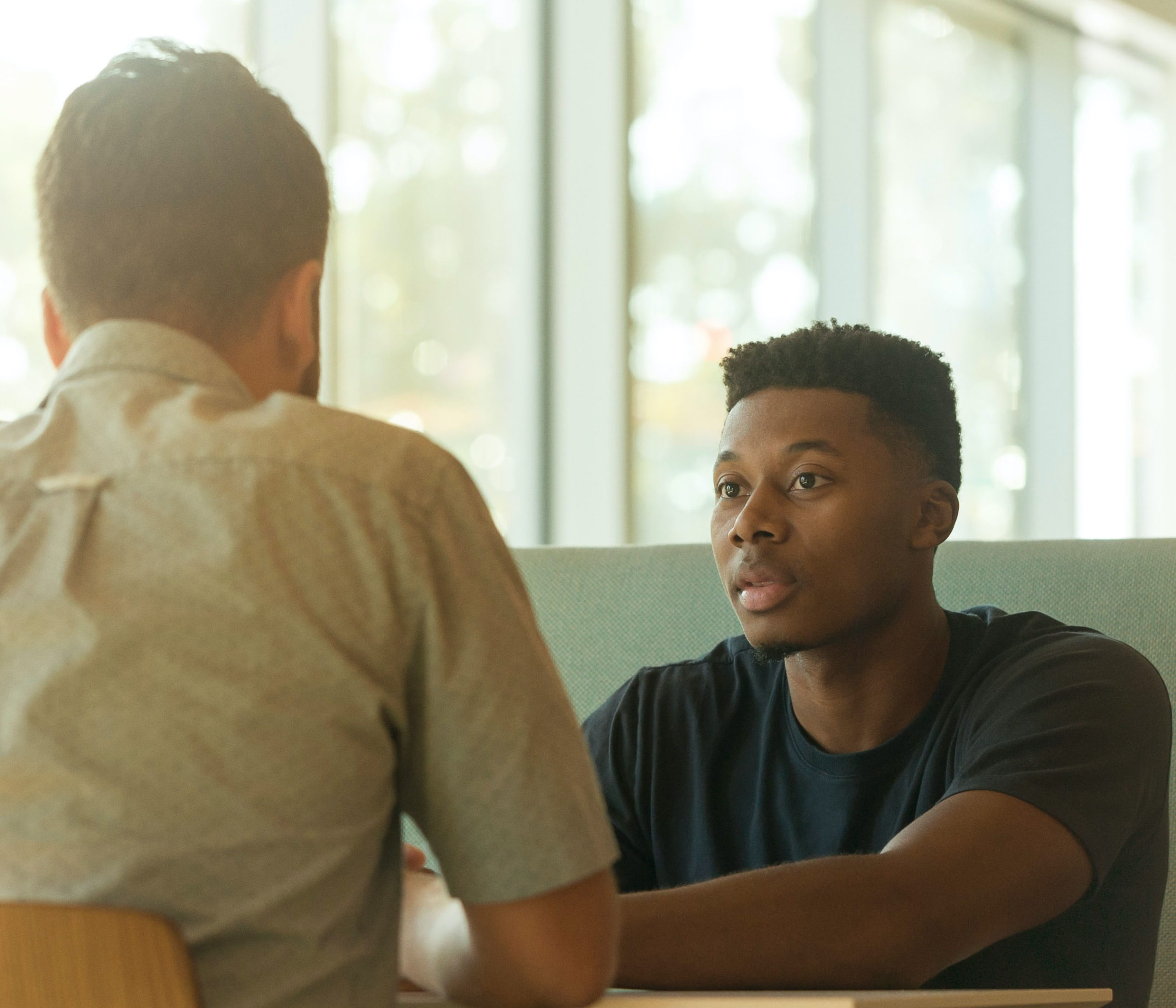 Doctor talking to a young patient in a clinical environment