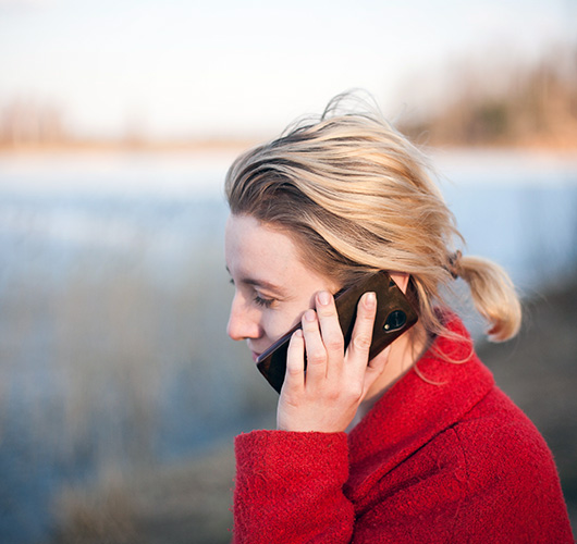 woman speak on mobile phone in a red coat