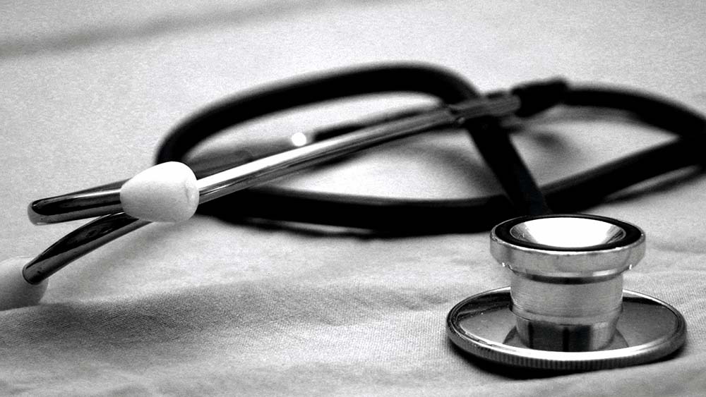 A stethoscope on a white sheet 