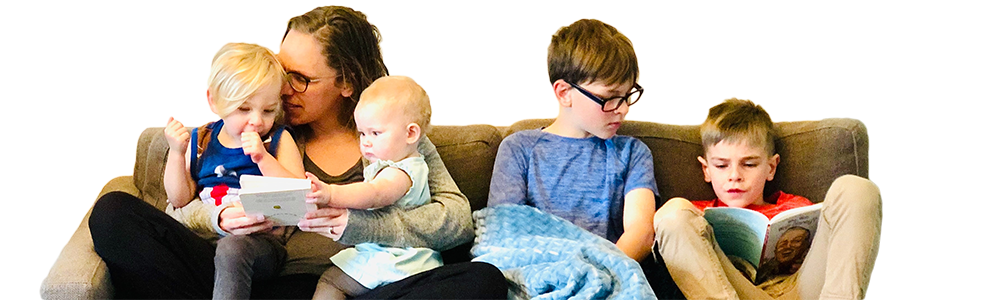 Mother and four children sitting on a sofa