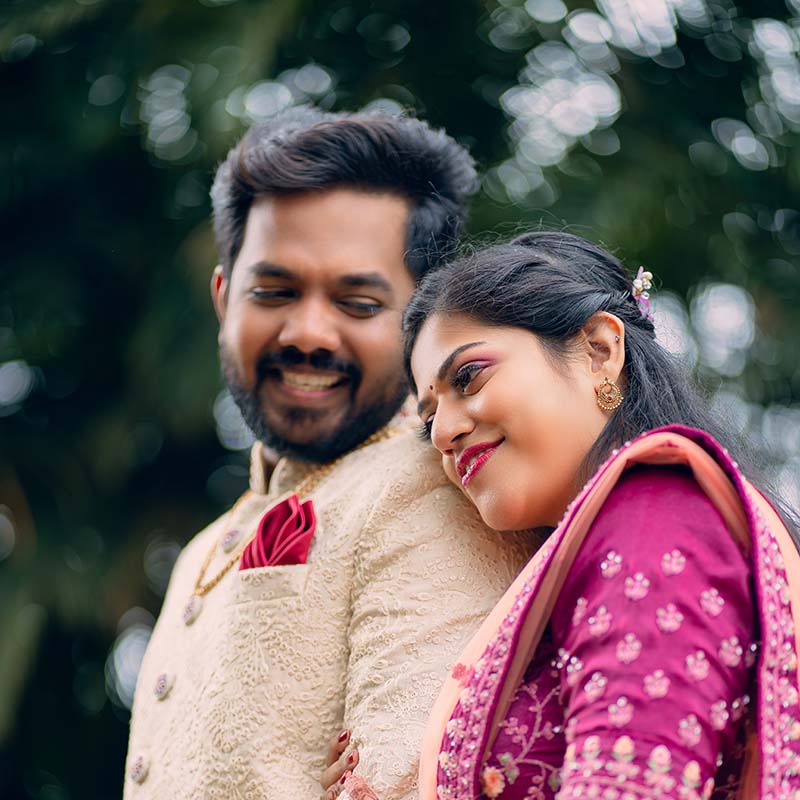 South Asian couple smiling with the woman