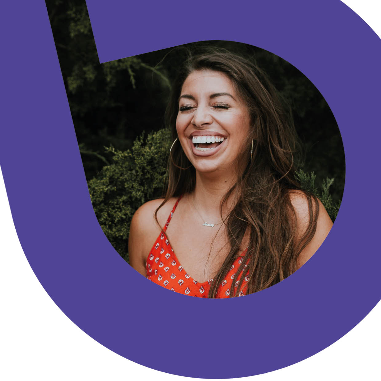 Woman in red dress laughing with her eyes closed