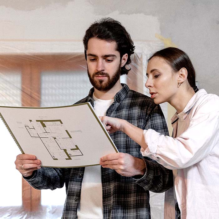 A couple looking at interior design plans