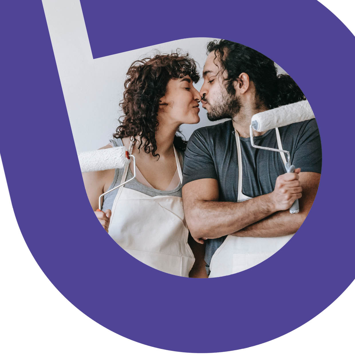 A man and woman holding paint rollers and kissing